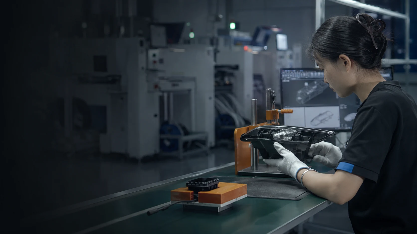 DXZ technician inspecting an automotive lighting unit during warranty and quality review.